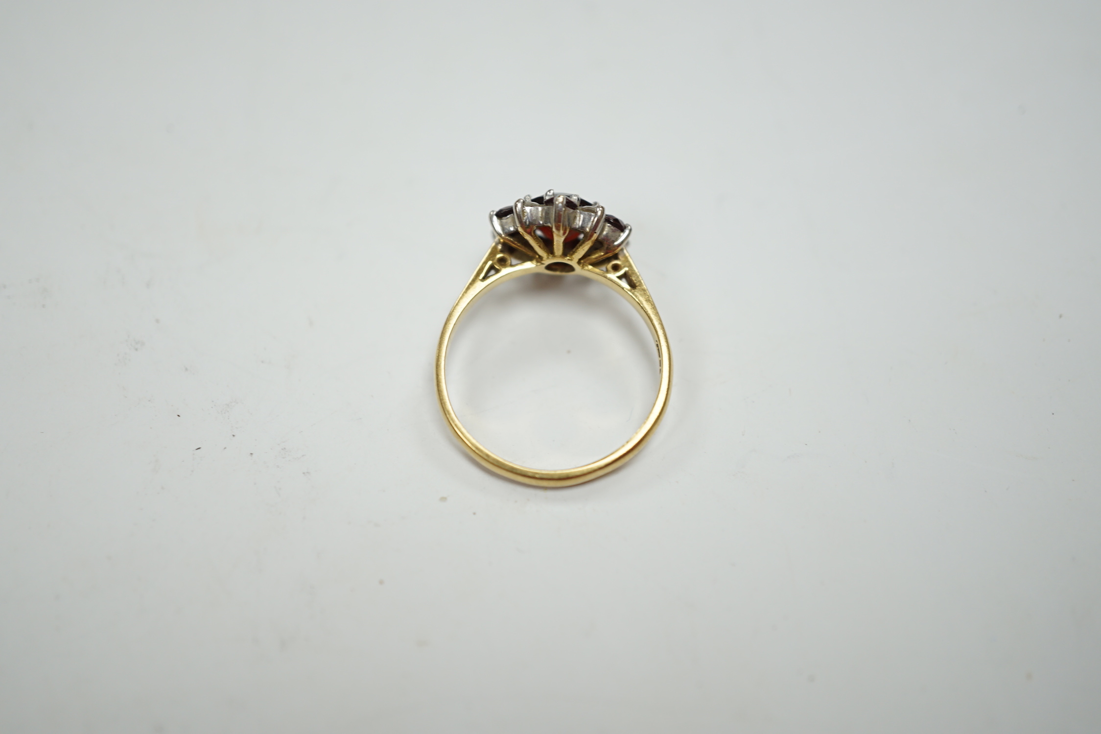 An 18ct red paste? and diamond cluster set flower head ring, size M, gross weight 3.2 grams.